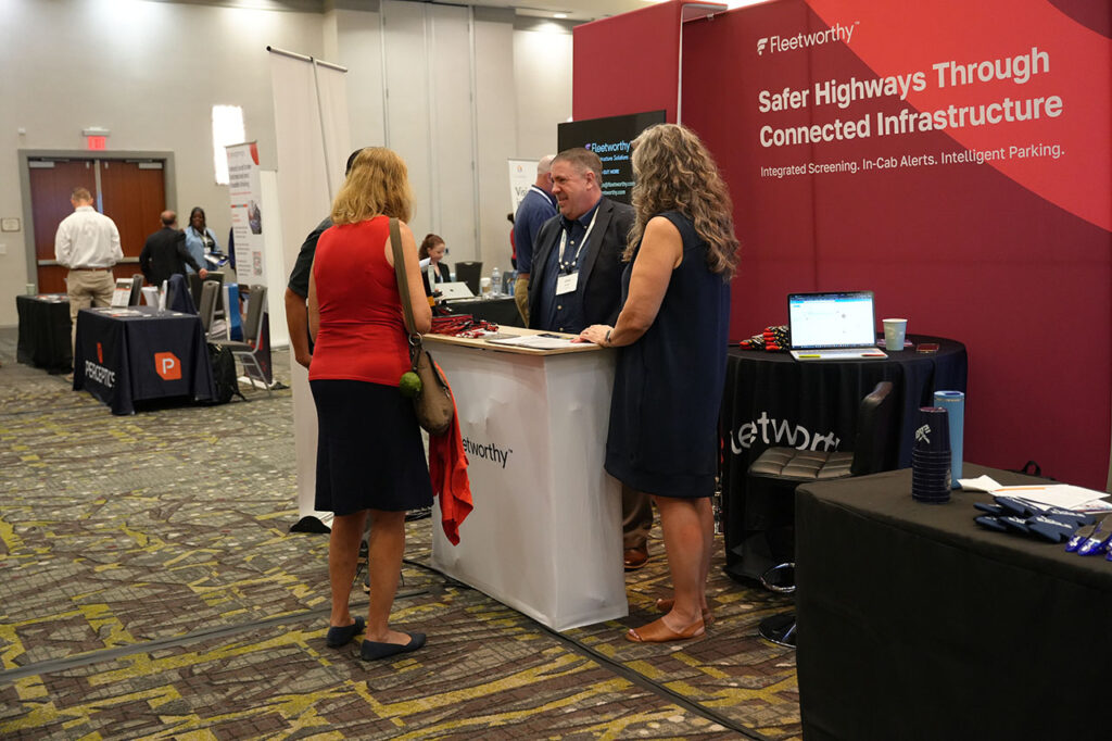 Attendees speaking with an exhibitor