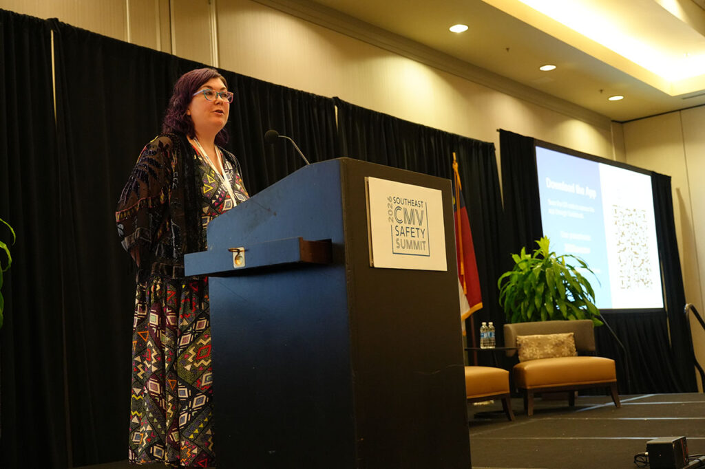 Presenter speaking at the podium during a Summit general session