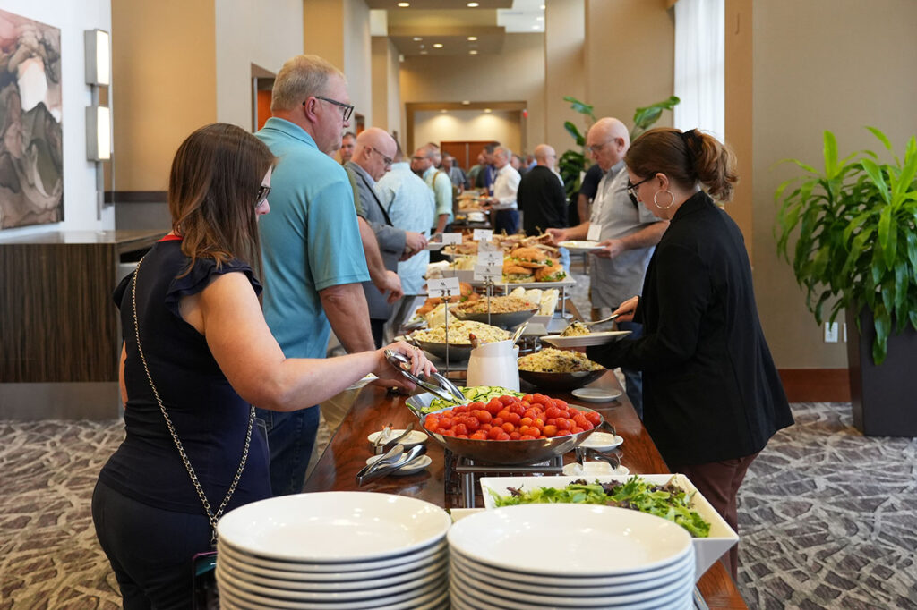 Attendees being served food at the Summit lunch buffet