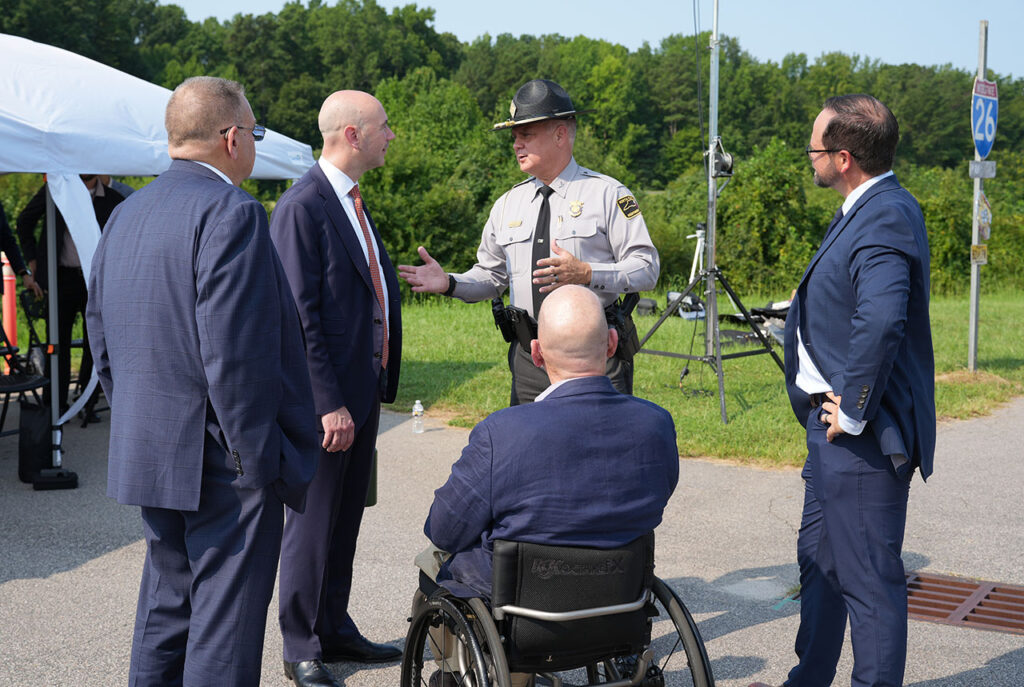 State trooper speaking with guests at the Technology Showcase